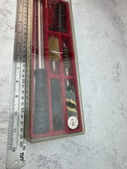 A 12-gauge shotgun cleaning kit in its original case. Italy
