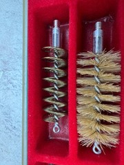 A 12-gauge shotgun cleaning kit in its original case. Italy