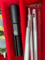 A 12-gauge shotgun cleaning kit in its original case. Italy
