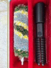 A 12-gauge shotgun cleaning kit in its original case. Italy