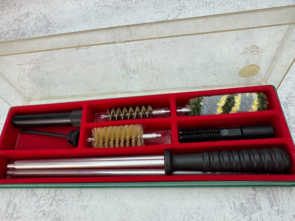 A 12-gauge shotgun cleaning kit in its original case. Italy