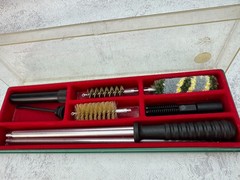 A 12-gauge shotgun cleaning kit in its original case. Italy