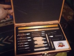 Pre-Owned DAC Gunmaster Deluxe Universal Gun Cleaning Kit with red wooden Case.
