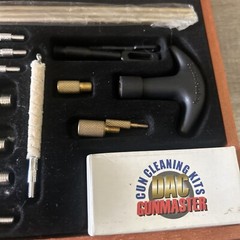 Pre-Owned DAC Gunmaster Deluxe Universal Gun Cleaning Kit with red wooden Case.