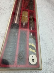 A 12-gauge shotgun cleaning kit in its original case. Italy